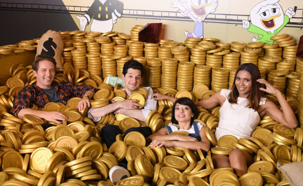 The cast of the new DuckTales hang out in the money bin at D23 Expo 2017. L-R: Beck Bennett (Launchpad), Ben Schwartz (Dewey), Kate Micucci (Webby) and Toks Olagundoye (Mrs. Beakley).